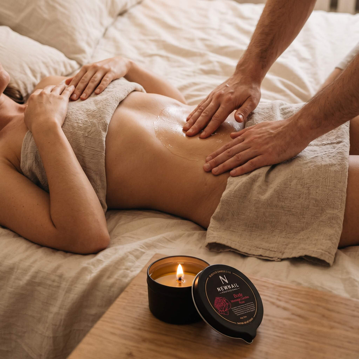 Couple's massage with warm oil from the rose massage candle